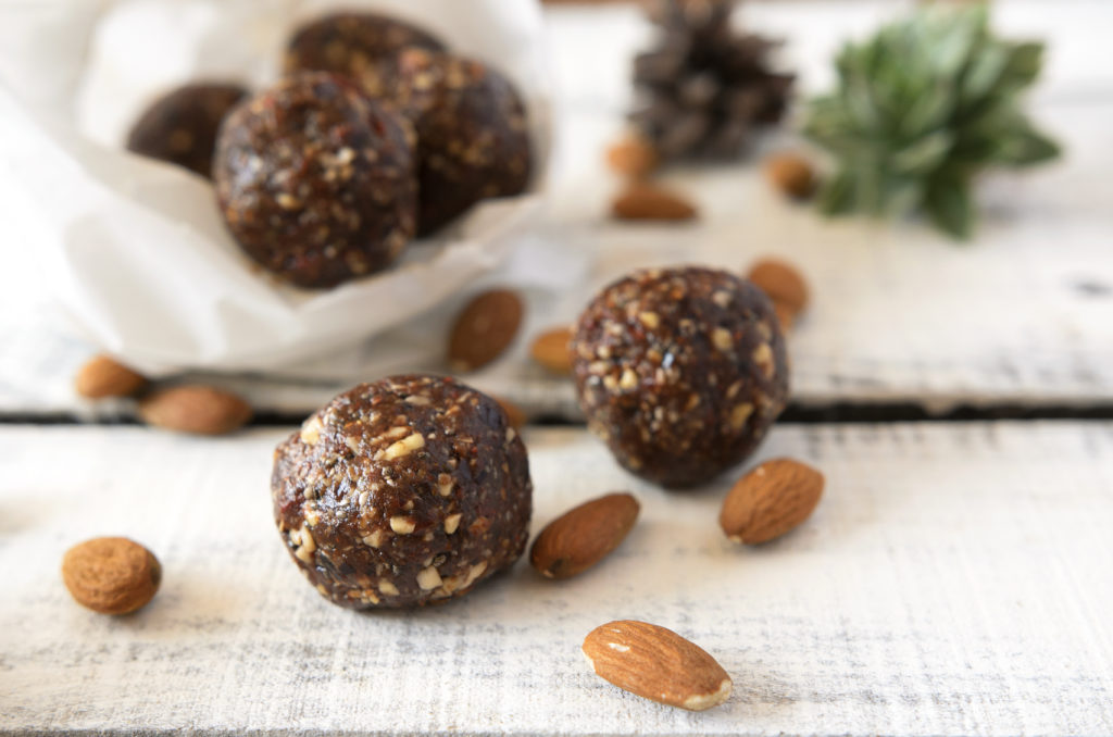 Vegan sweet delicious almond cocoa balls healthy and tasty food on wooden table